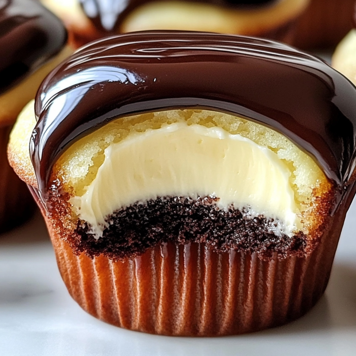 Indulge yourself with these Decadent Boston Cream Cupcakes! They're the perfect treat to satisfy your sweet cravings with a luscious vanilla cream filling and rich chocolate ganache on top. Let's get baking! 🎉